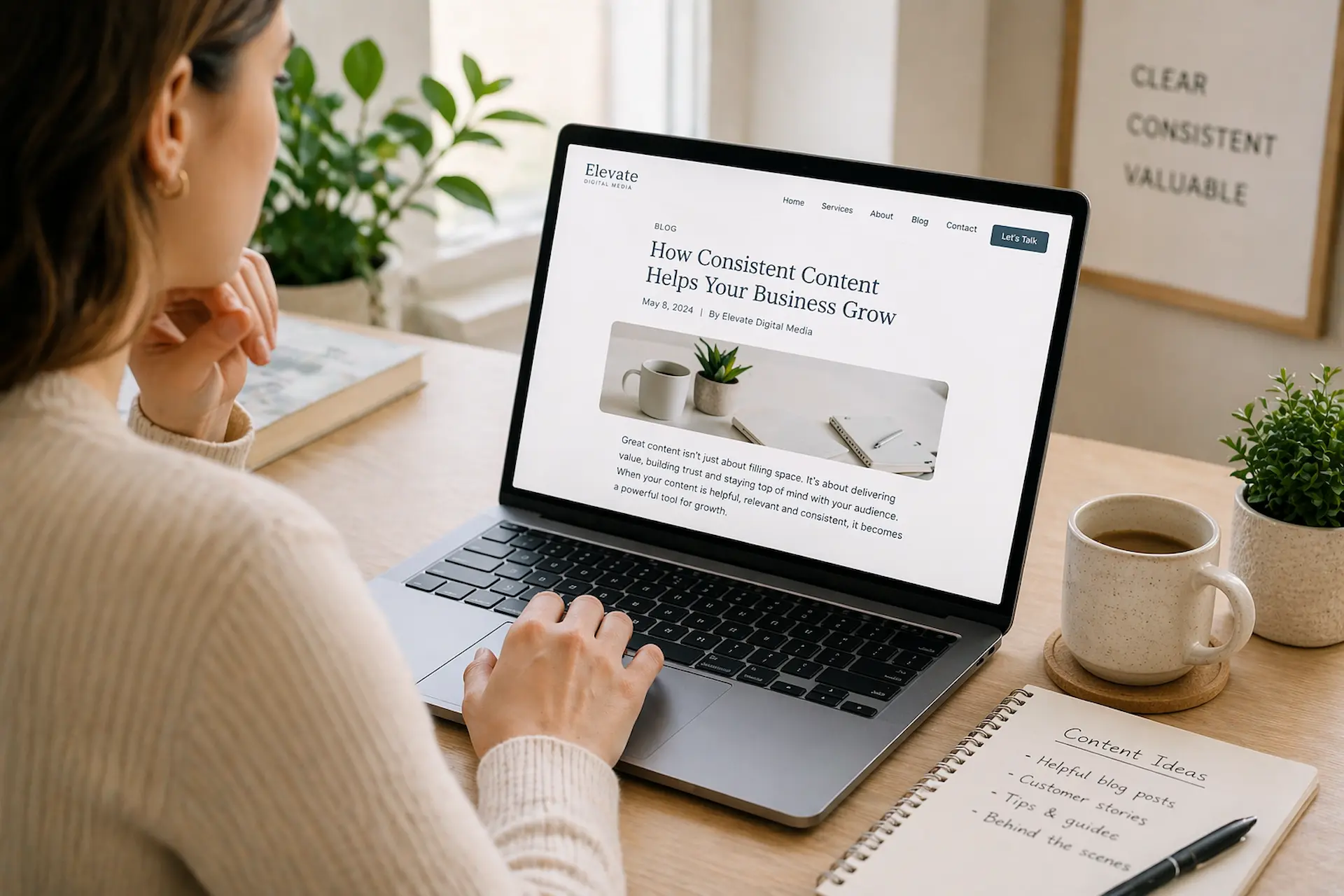 Person reading blog content on a laptop in a clean, modern workspace